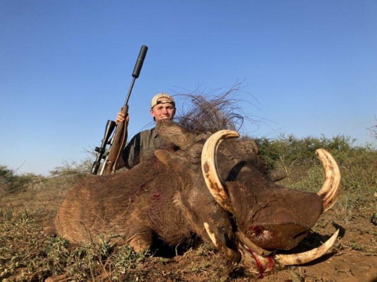 Teenager posing with his Rowland Ward warthog.