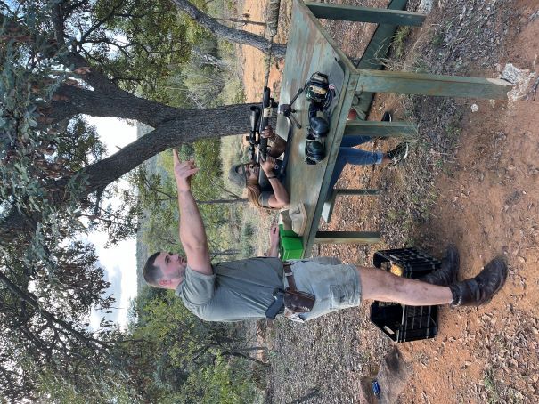 A PH instructing a hunter for shooting range practice