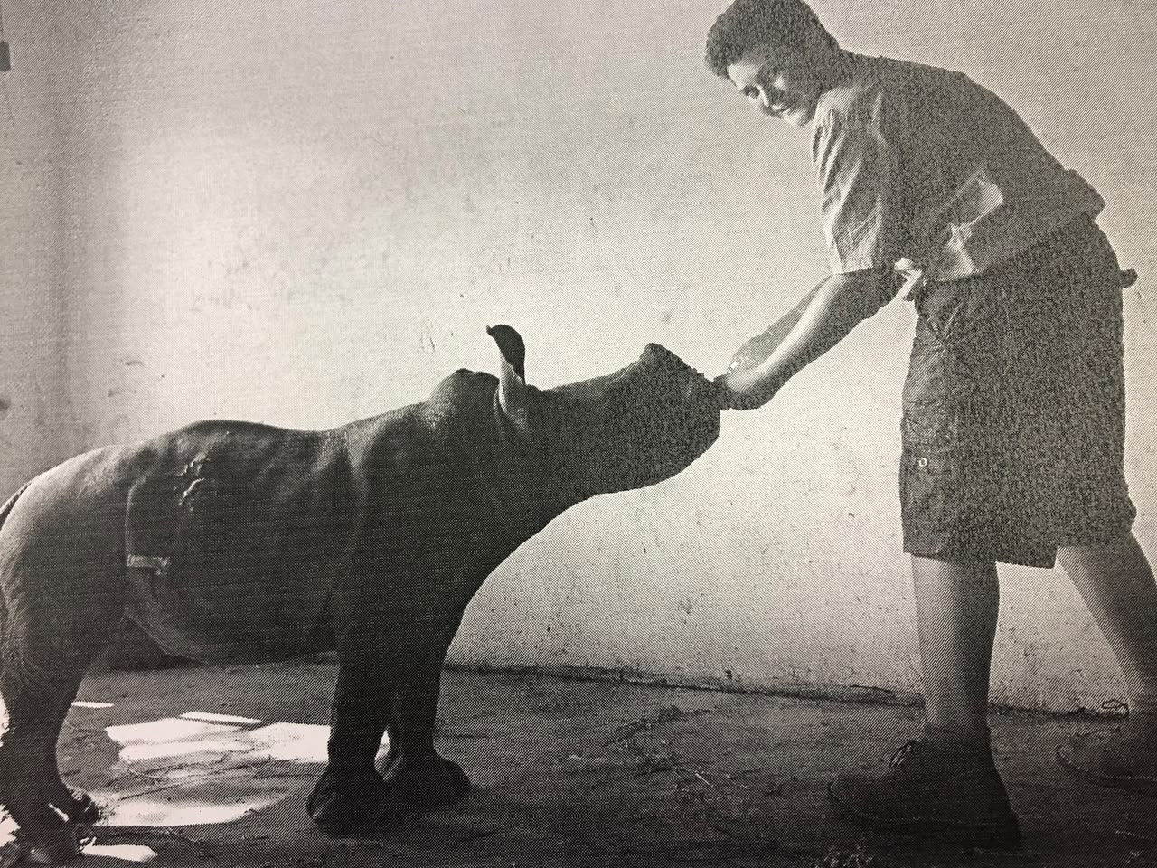 Keenan feeding an orphaned rhino calf at Rugania Game Farm.