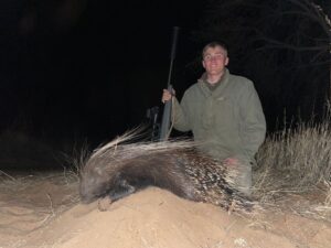 A man with his prized porcupine trophy