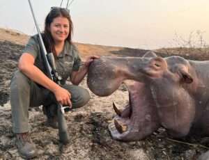 lady posing with hippo hunted